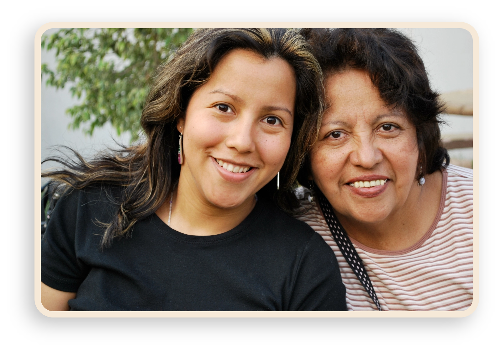 latino mother and daughter smiling