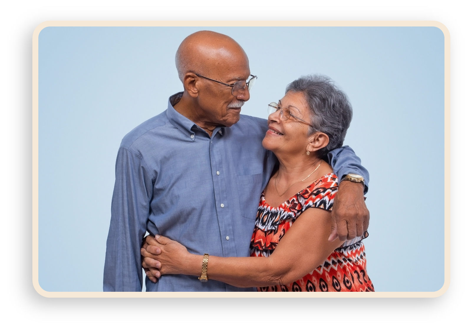 older latino couple hugging and smiling