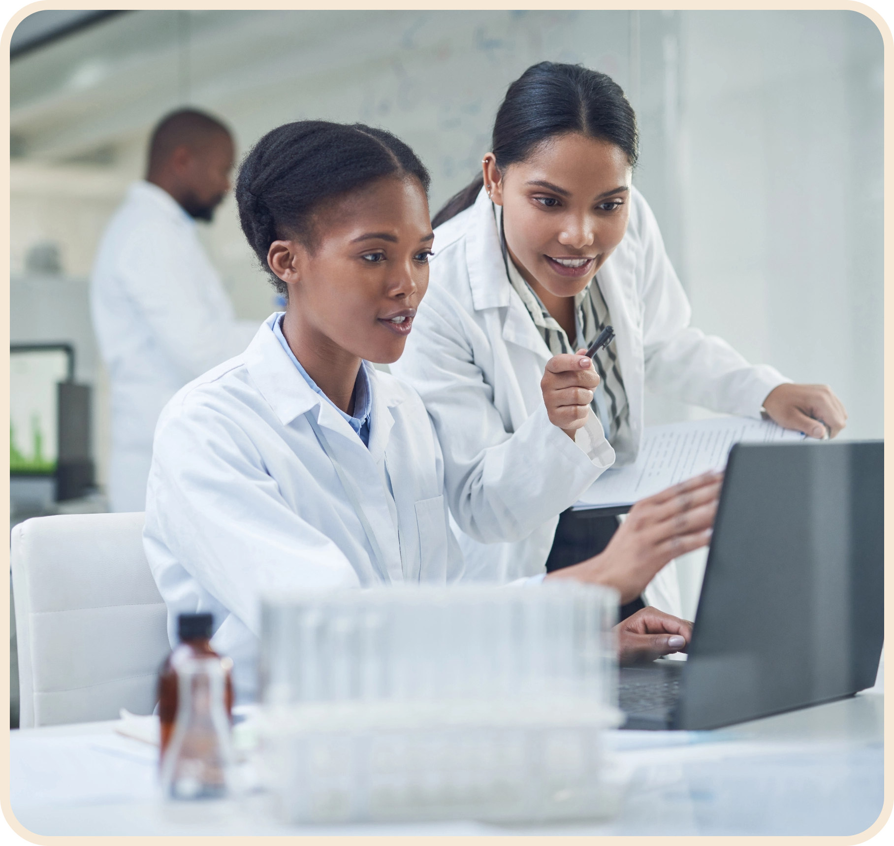 two female researchers looking at computer screen